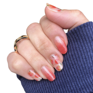 Peach coloured and peach pattern nail wraps on medium nails