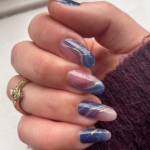 blue and pink sheer nail wrap with gold glitter on long nails